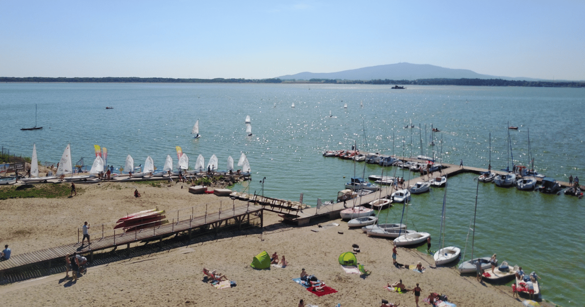 Plaża z pomostami i przystanią żeglarską nad Zalewem Mietkowskim, w tle masyw Ślęży